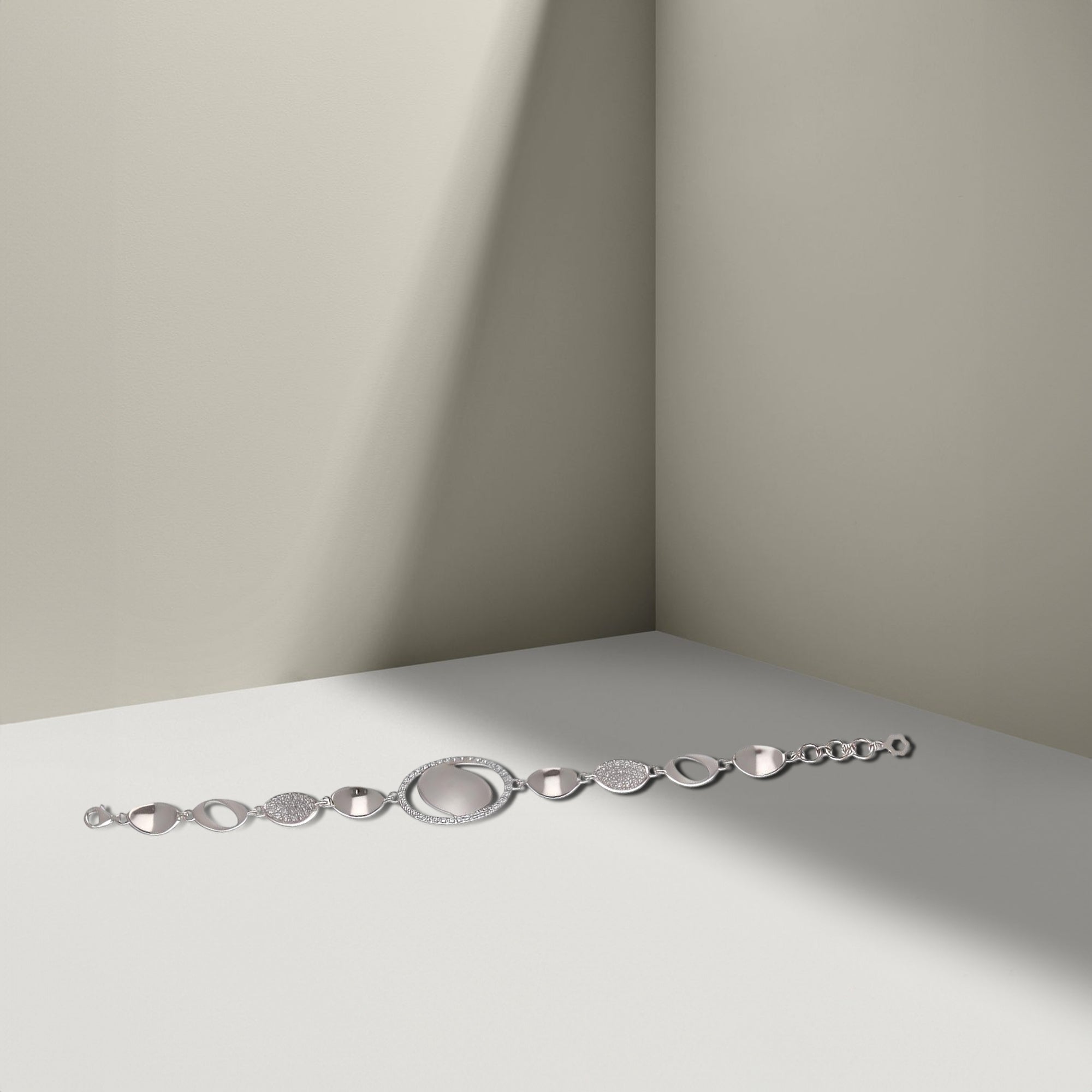 Elegant Silver Bracelet with Textured Ovals and Crystal Accents