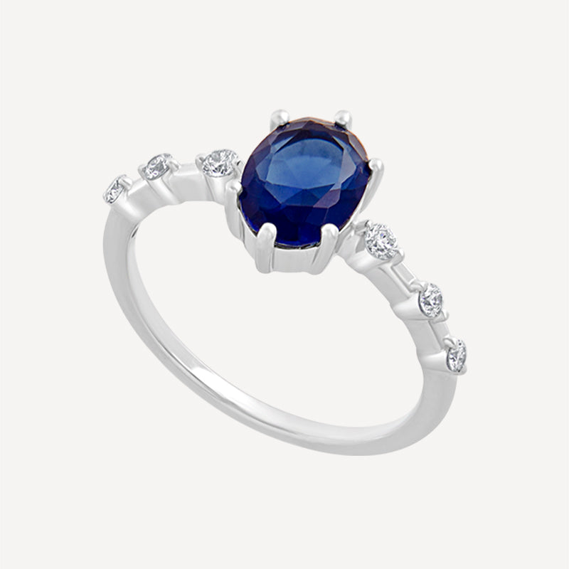 Silver Ring with Oval Blue Sapphire and CZ Side Accents